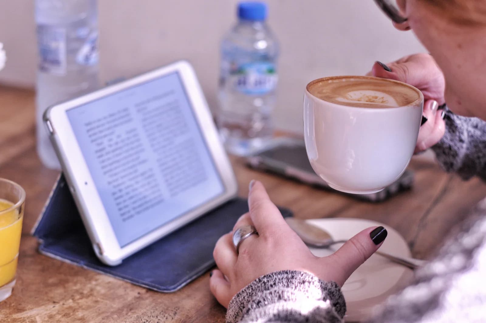 Person reading a manuscript on a tablet