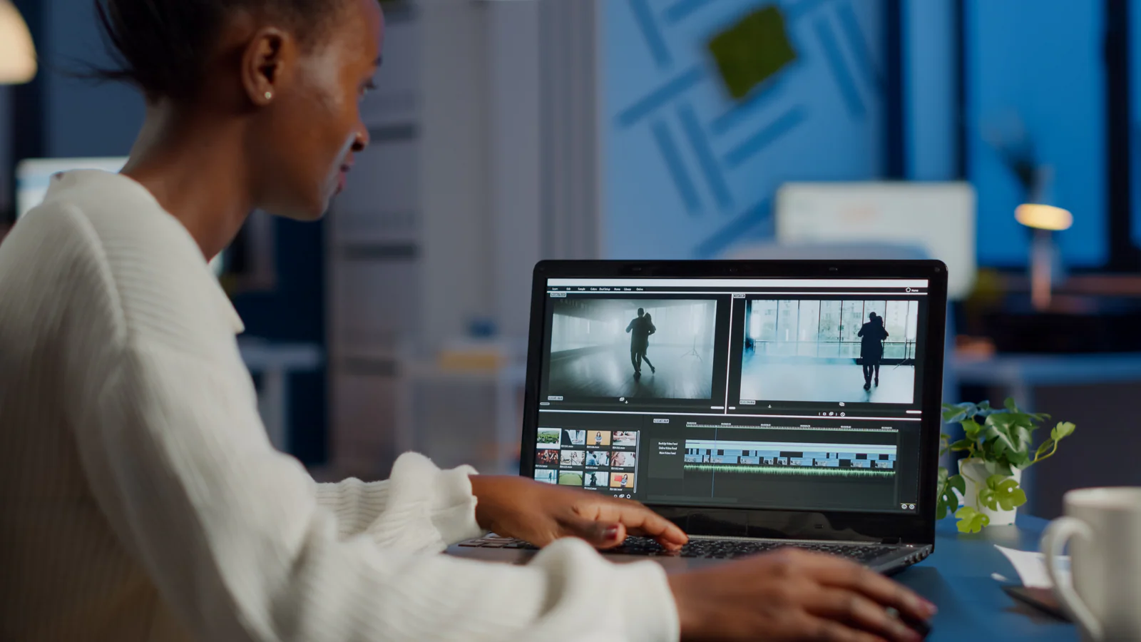 Editor reviewing video clips on a laptop